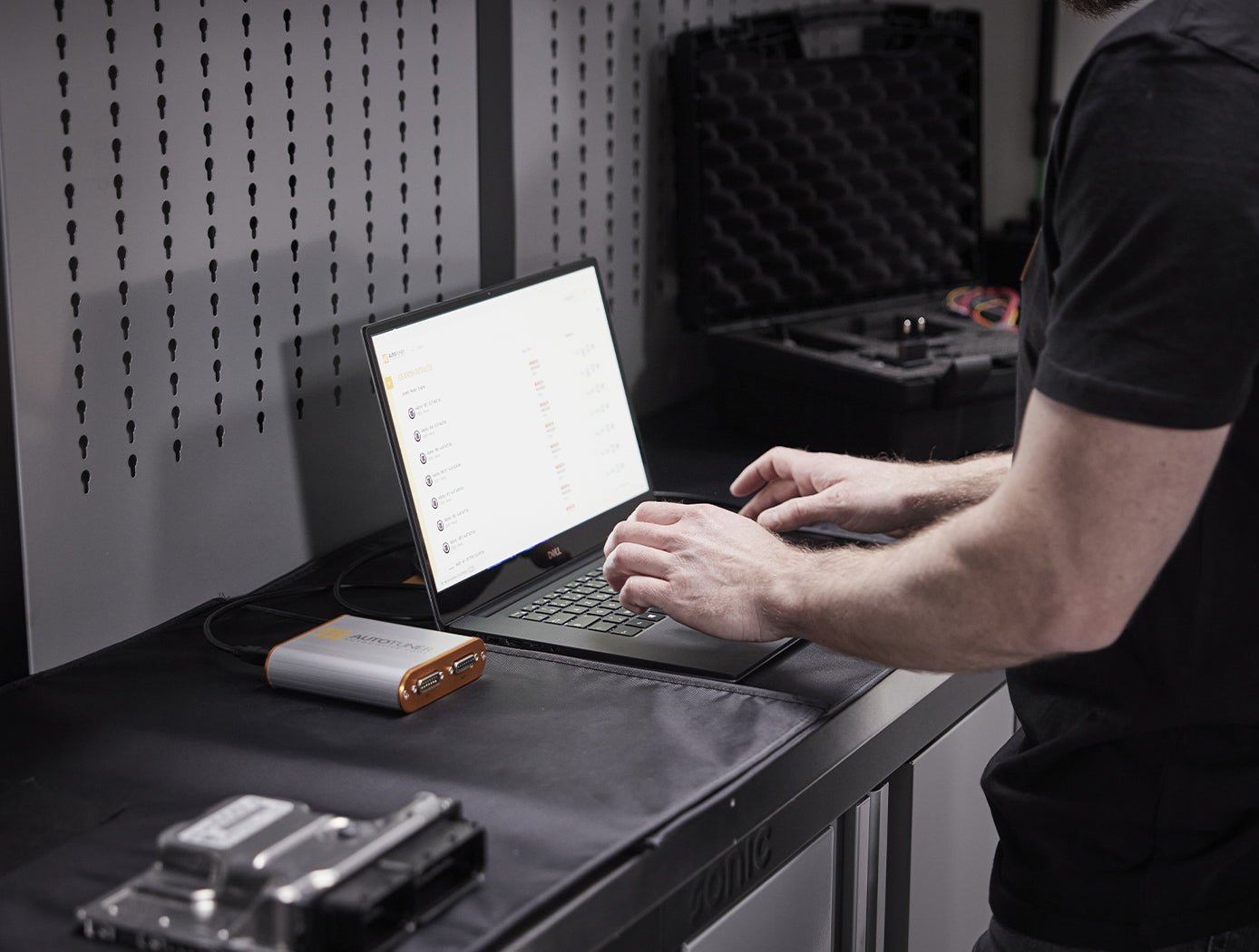 People using AutoTuner Tool in a garage 