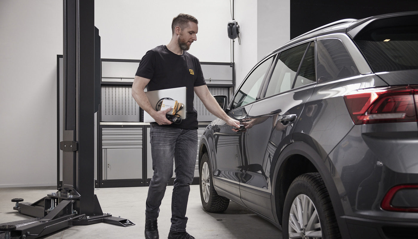 People working for autotuner with a car