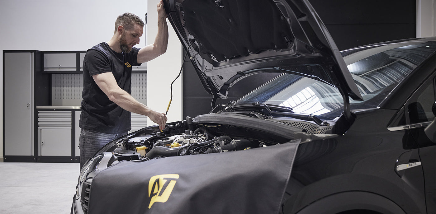 Man working in car engine with AutoTuner